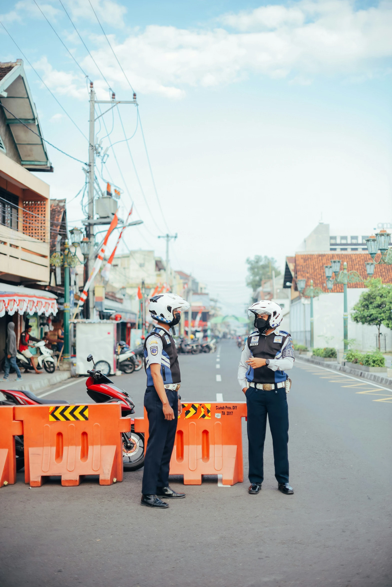 two security guards standing in the middle of a street