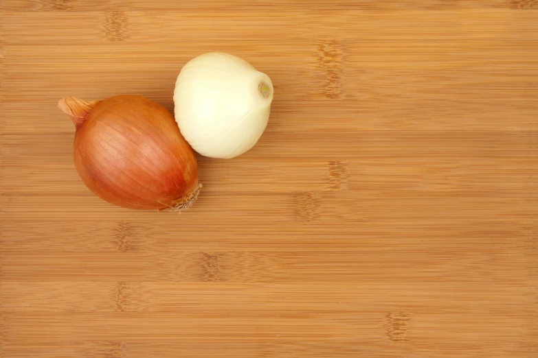 an onion and an onion on a wooden  board