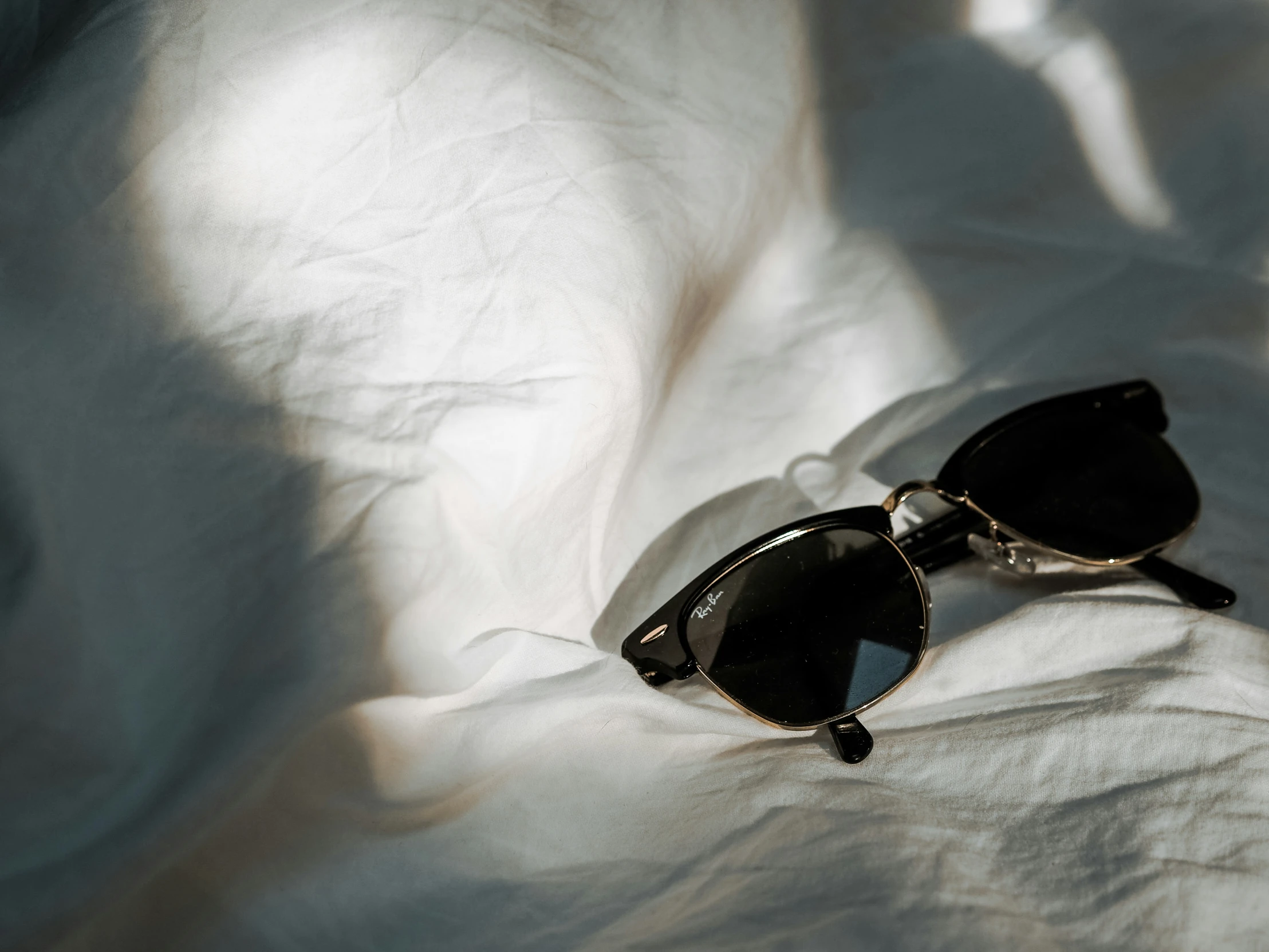 a pair of sunglasses lying on a blanket