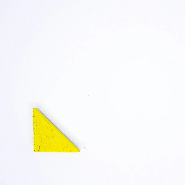 a yellow object is placed on the white surface