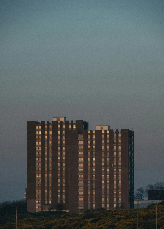 a very tall building in the evening light