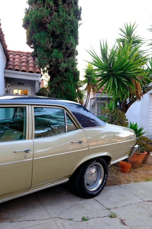 an old station wagon sitting in front of a house