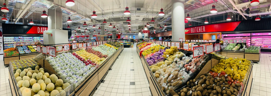 a produce section with fruits and vegetables in baskets