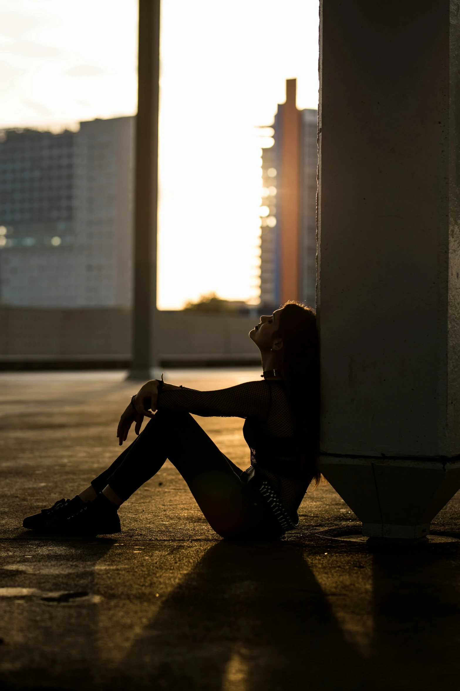 a woman sitting on the floor in a building