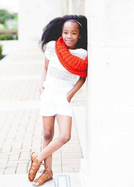 a girl poses in the corner for a pograph