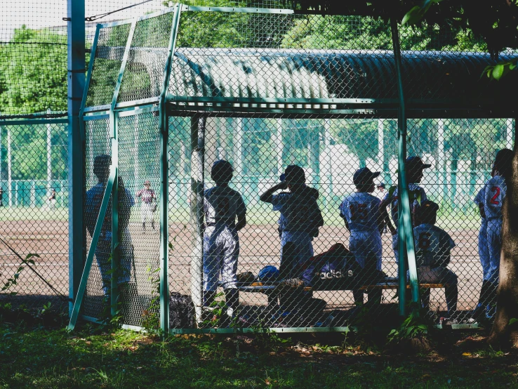 a baseball game is in the dark and the batter is waiting