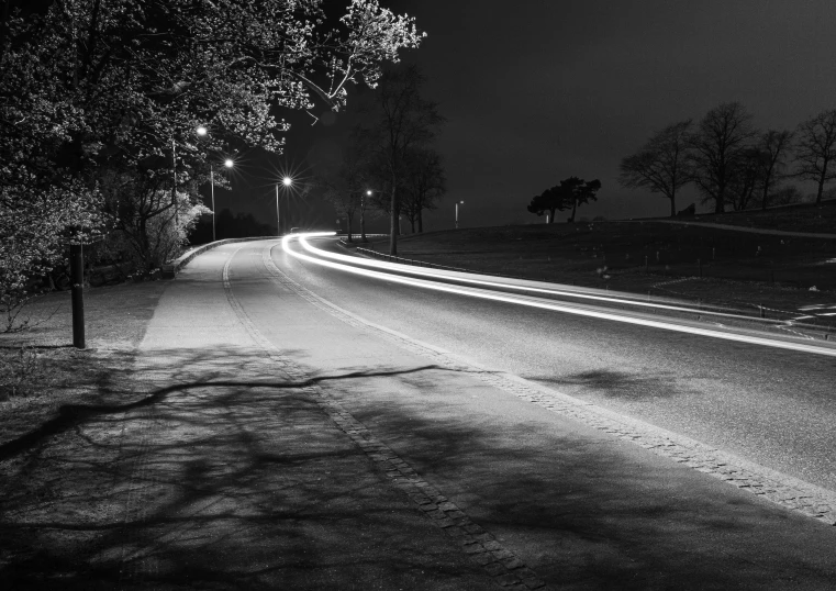 a dark road lit up with street lamps