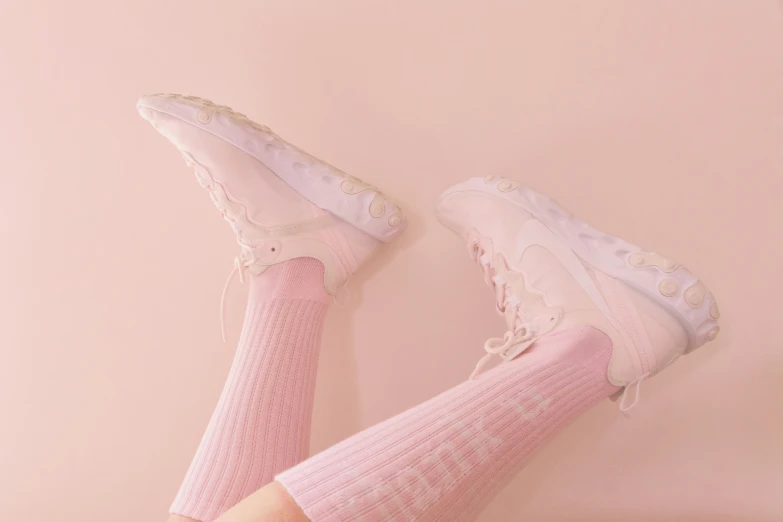 a pink pair of tennis shoes on a floor