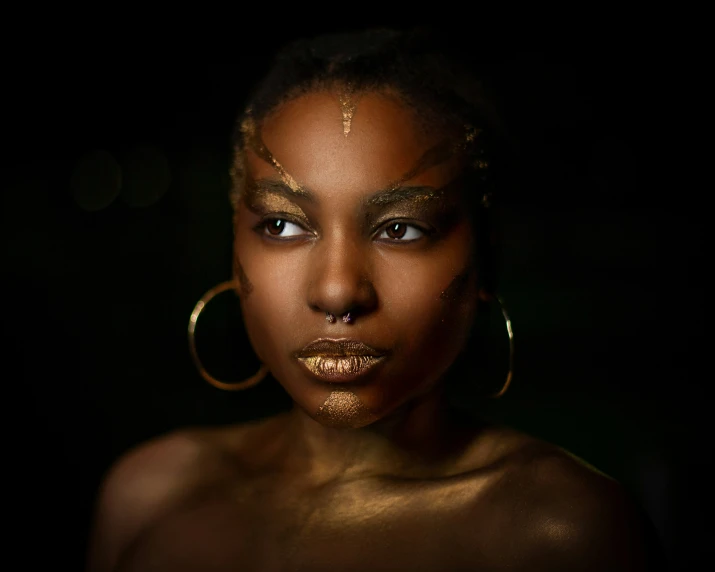 an african woman wearing gold face makeup