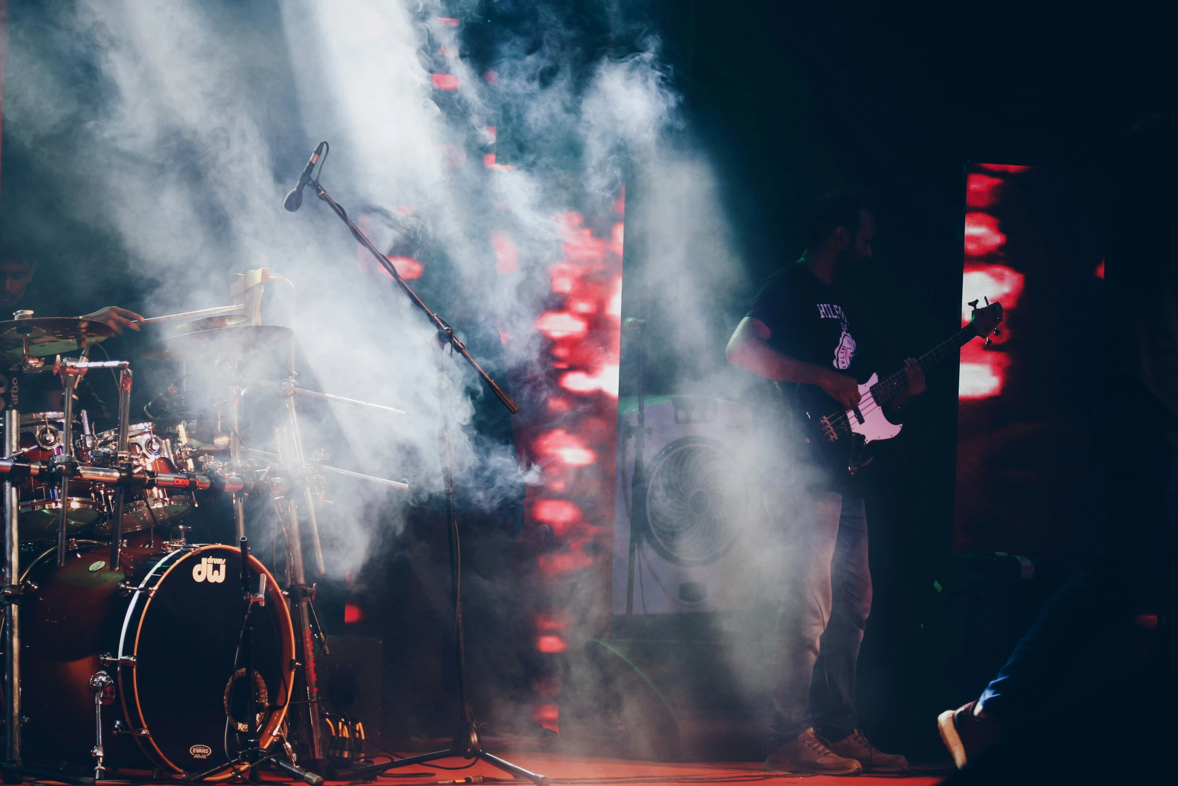 three men in a band on stage performing on their guitars