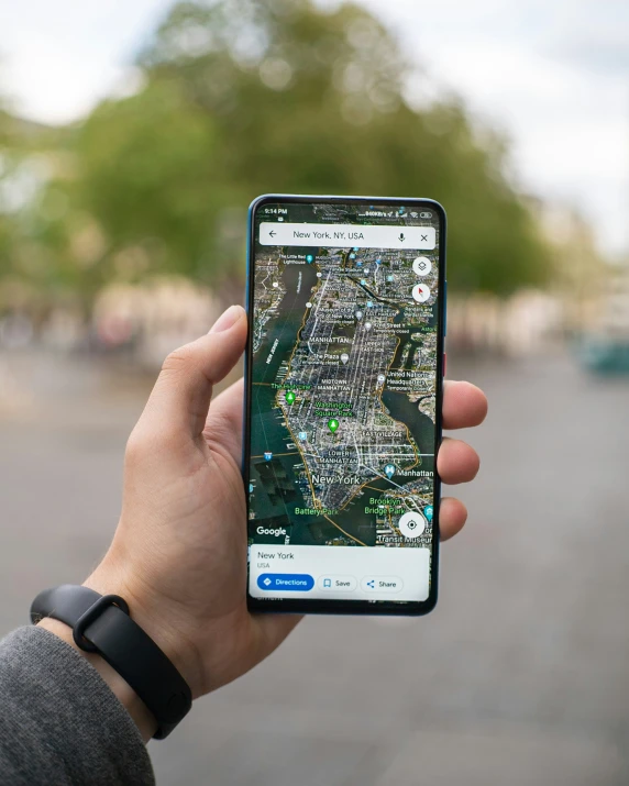 someone holding up a phone displaying a map