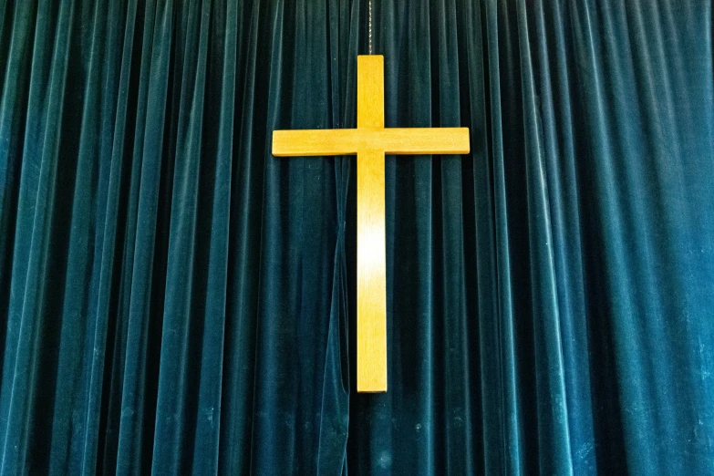 the cross on top of the curtain is yellow