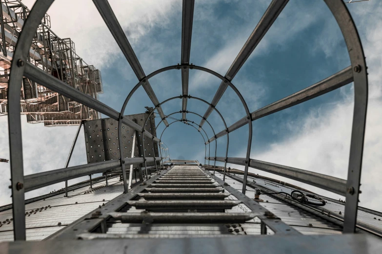 a metal stairway with many steps going up the side