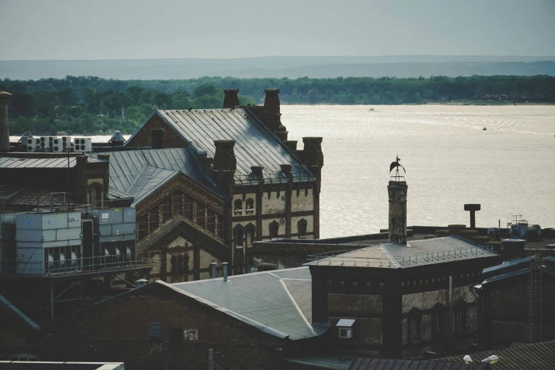 a boat out in the water next to a church and some buildings