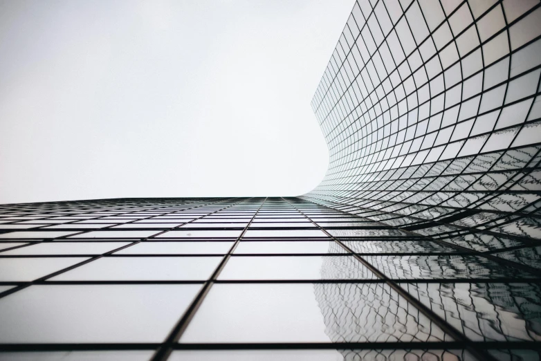 a tall building with windows next to a sky background