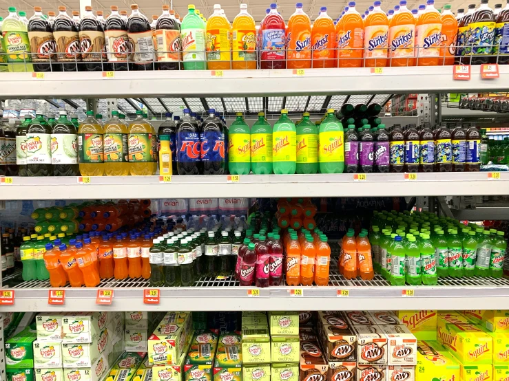 the shelves are filled with juice and condiments