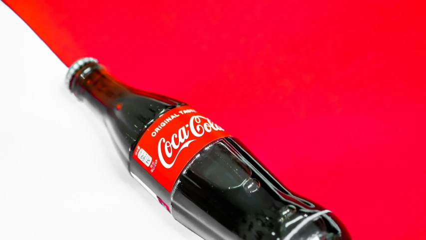a close up of a bottle on a red background