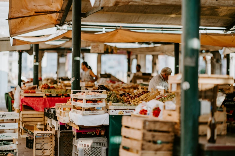 a large outdoor fruit market selling goods