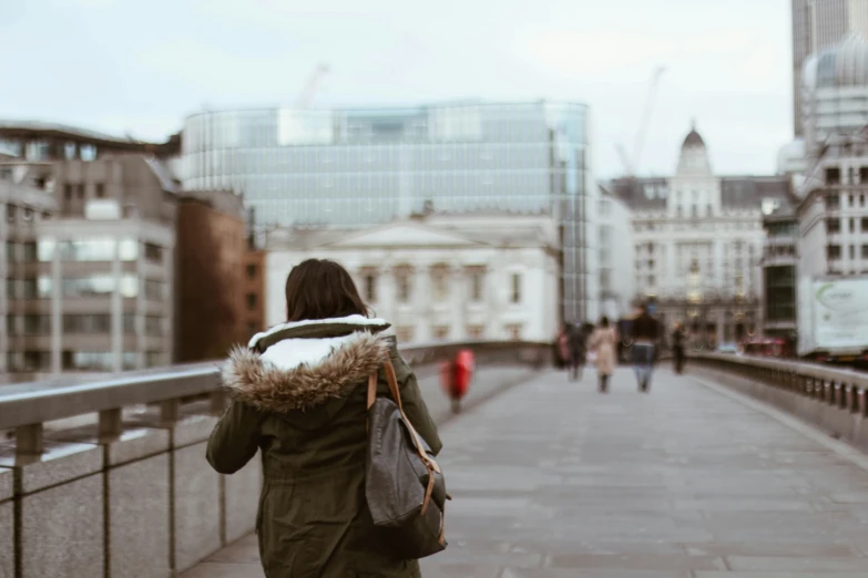 a person walks down a walkway holding a book