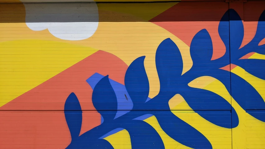 a blue flower on a yellow and red door