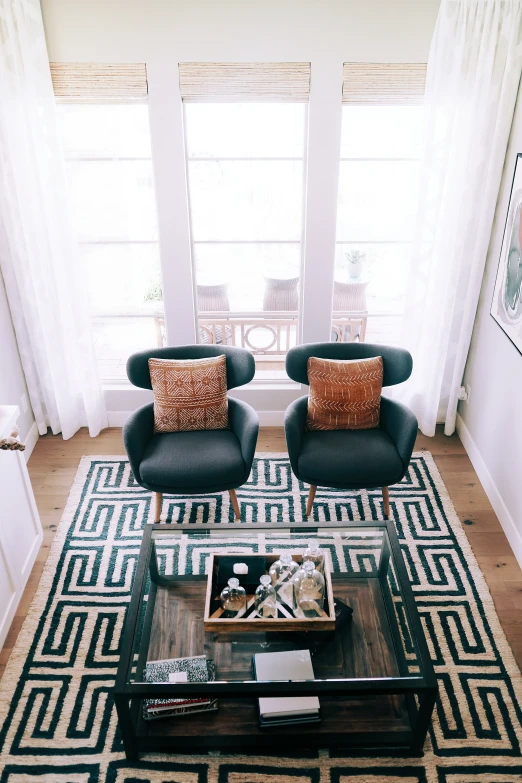 two chairs and a coffee table with books on it