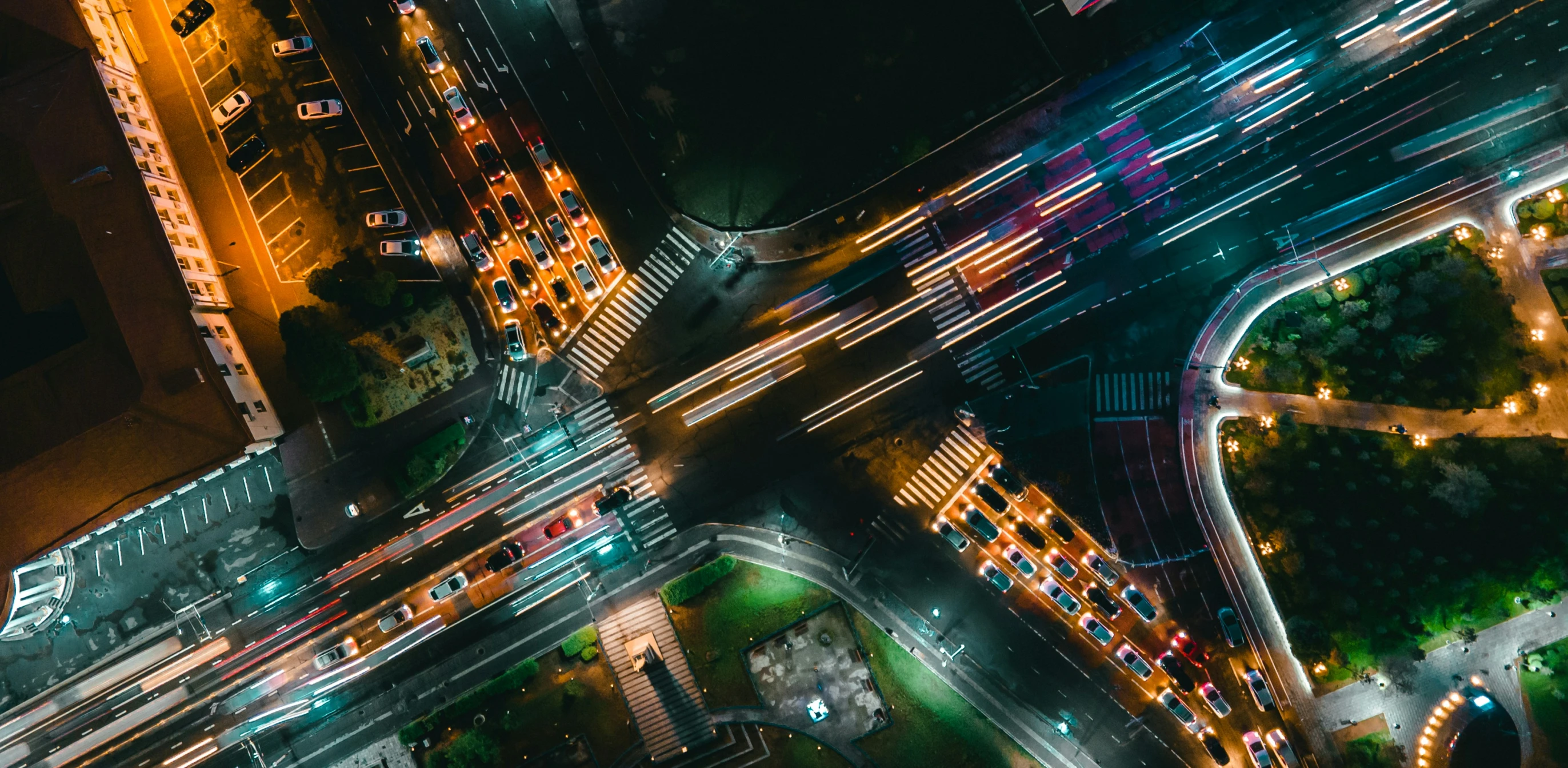 a night time view looking down at a street intersection