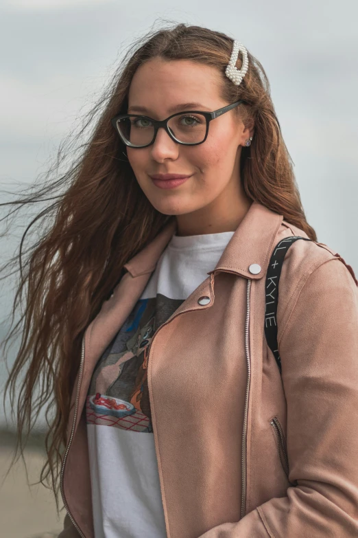 a young lady with long hair wearing a brown leather jacket