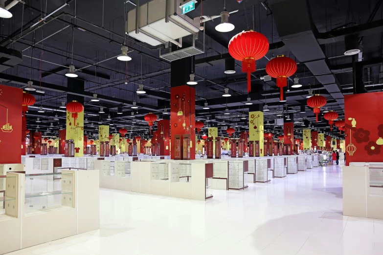 a room filled with red lanterns and tables in it