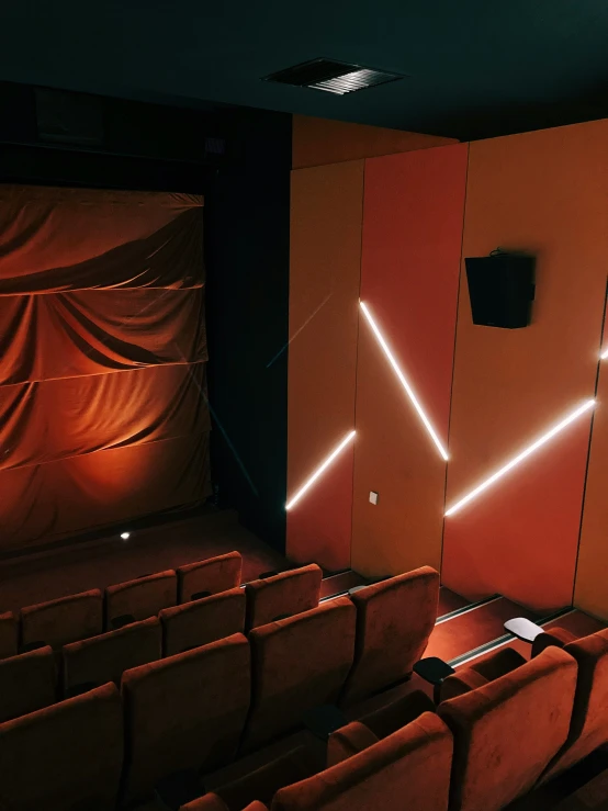 there is a movie theater with red curtains