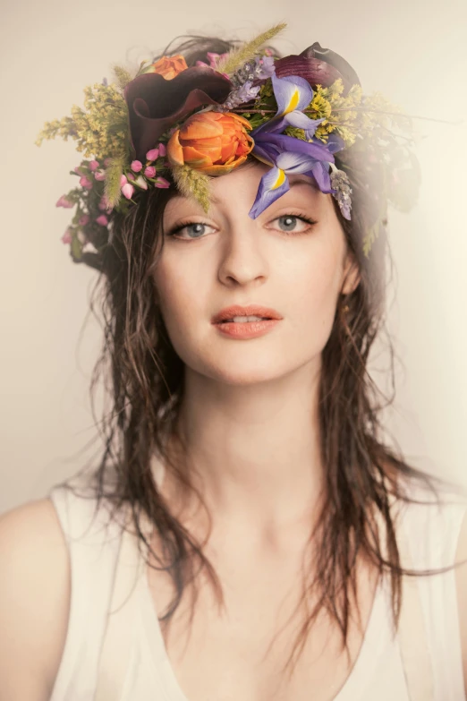 young woman with floral head piece in artistic fashion