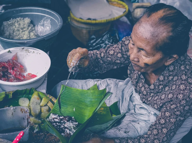 a woman sitting in front of a bowl of food