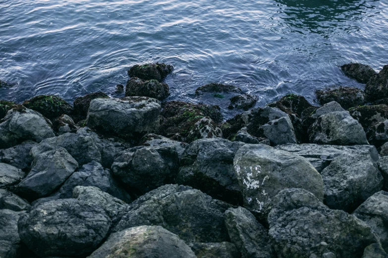 rocks and the sea with a large boat on the water