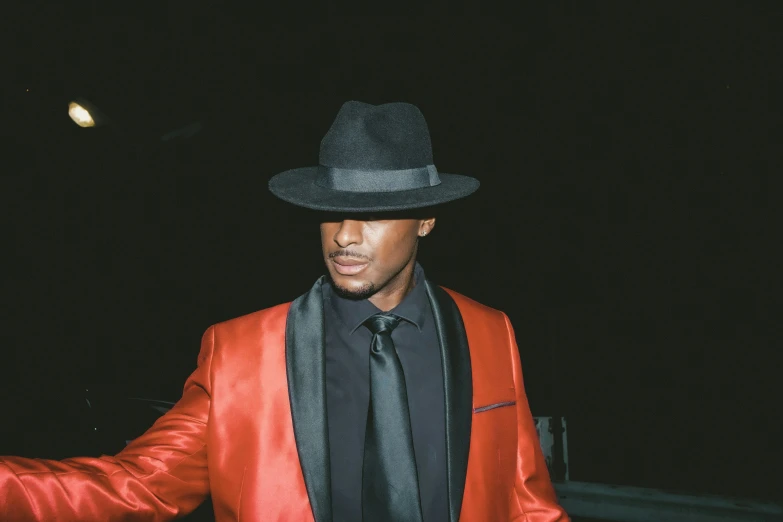 a man in a red jacket and black hat