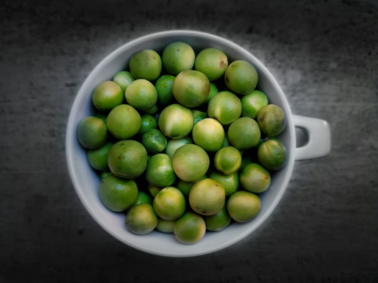 a bowl full of green fruit is shown here