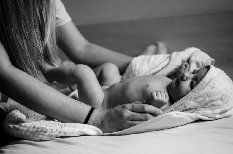 black and white pograph of a mother nursing her infant