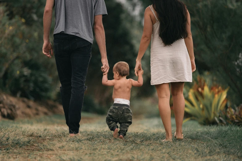 a family walking in the park holding hands