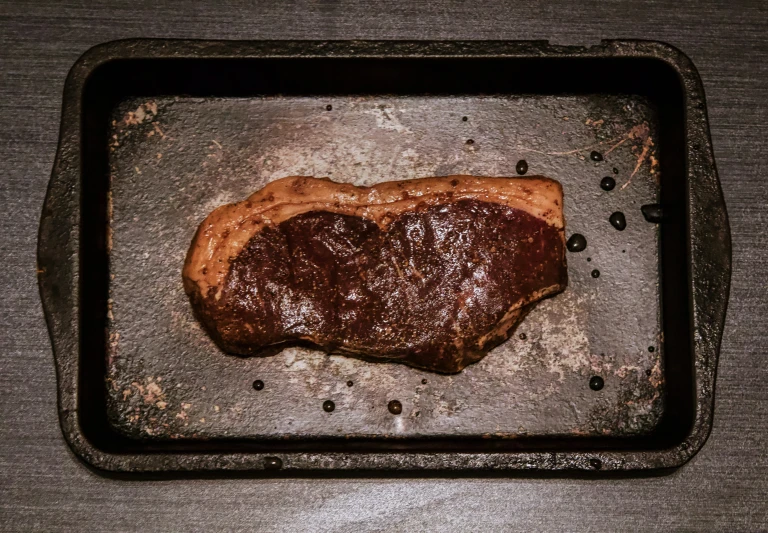 a steak steak is roasting in a grill