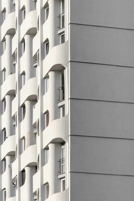 an office building with lots of windows and balconies on each floor