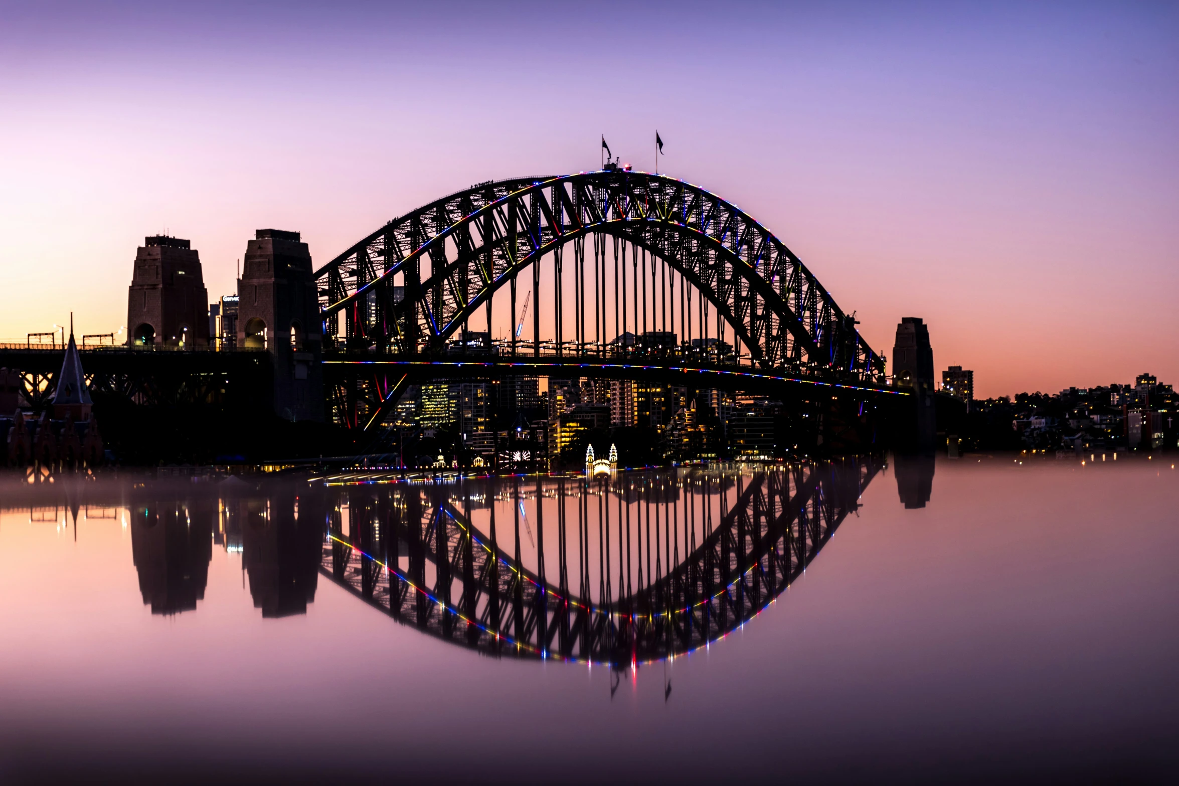 a tall bridge sitting above water next to a city