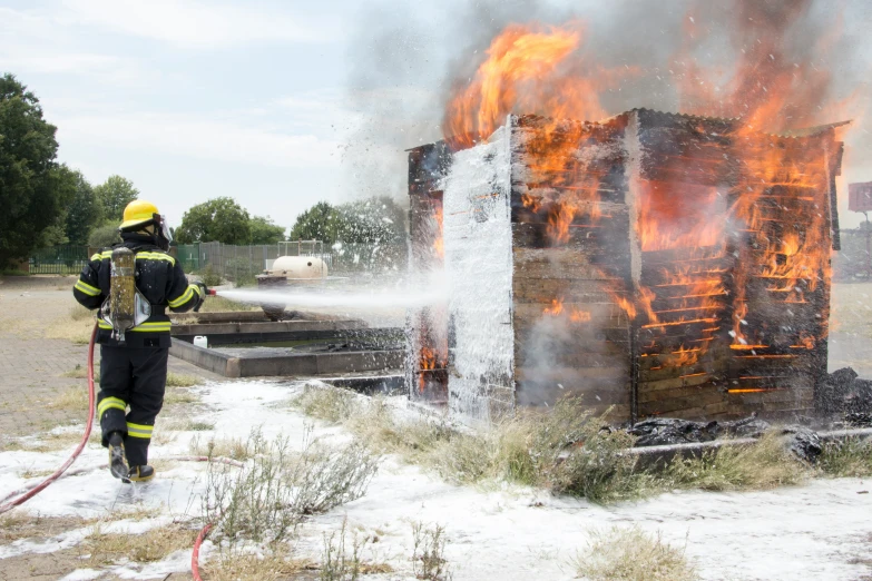 two firemen standing in front of a stack of fire
