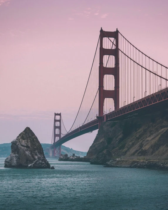 a suspension bridge stretches over a body of water