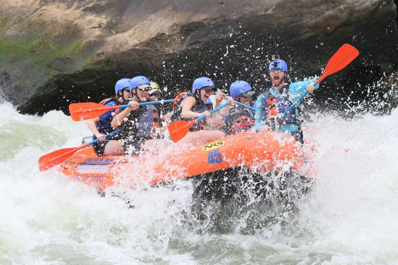 people are rafting in the water with one boat in front