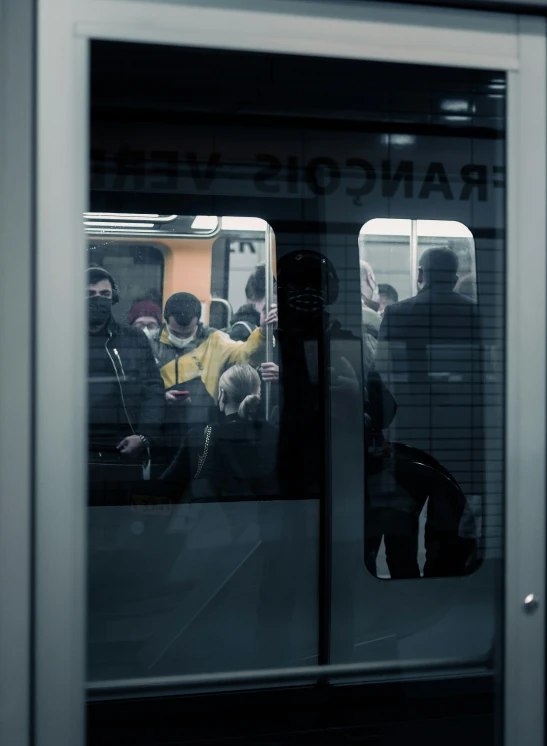 some people on a subway looking out the window