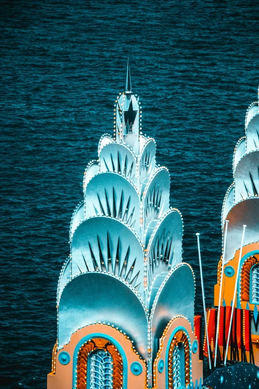 a tall building with lots of colorful decorations near the ocean