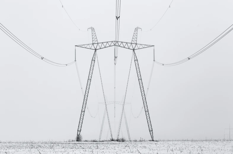 electric towers and wires on the snow covered ground