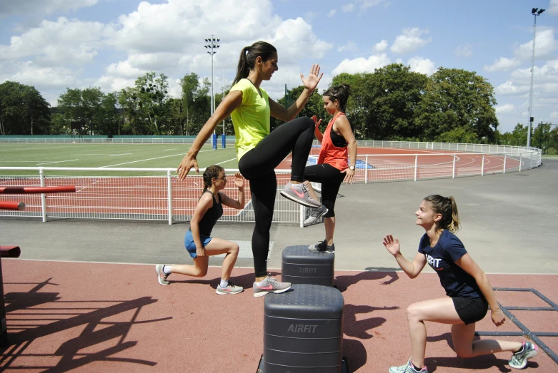 a group of young women training with trainer doing exercises