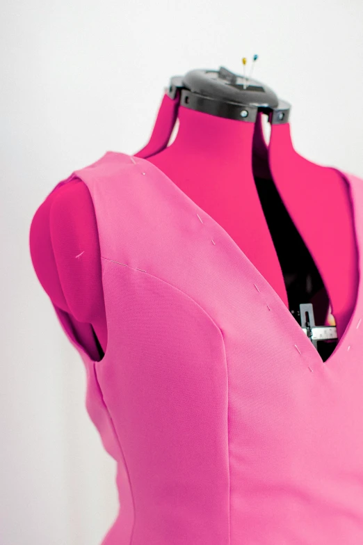 a dress made with pink fabric that is slightly unoned