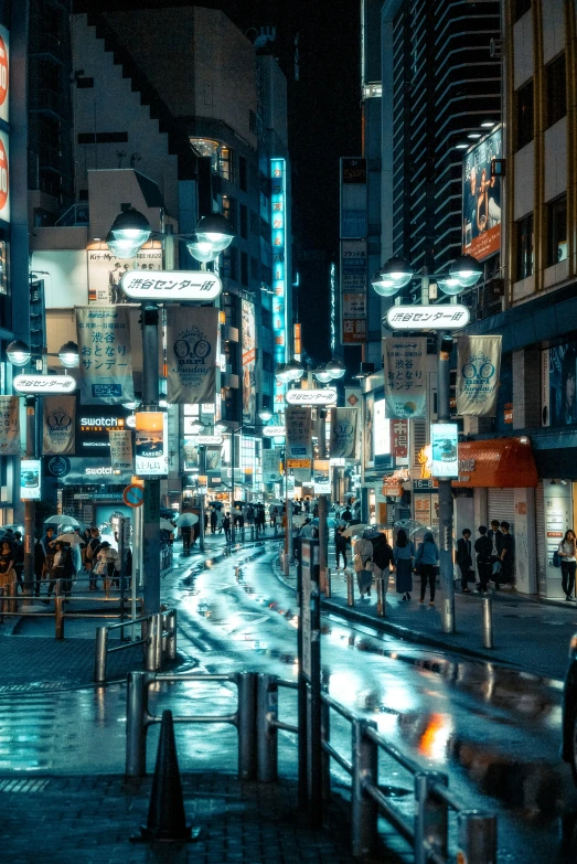 some people on the street some neon signs and buildings