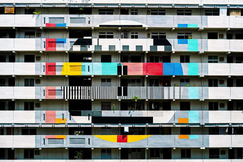 multicolored balconies and window boxes are in a large building