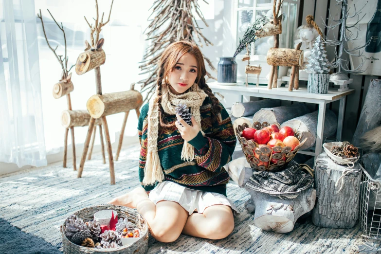 a young woman sitting on the floor and holding a basket